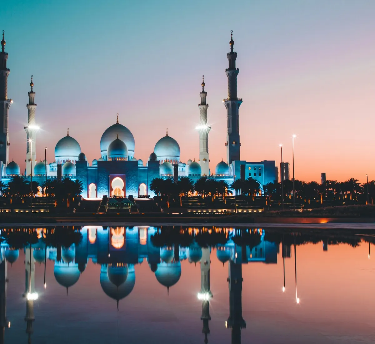 Sheikh Zayed Grand Mosque in Abu Dhabi, reflected in water at dusk